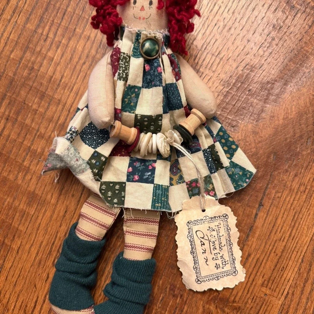 Handmade primitive Raggedy Ann style doll with red yarn hair and a quilted dress